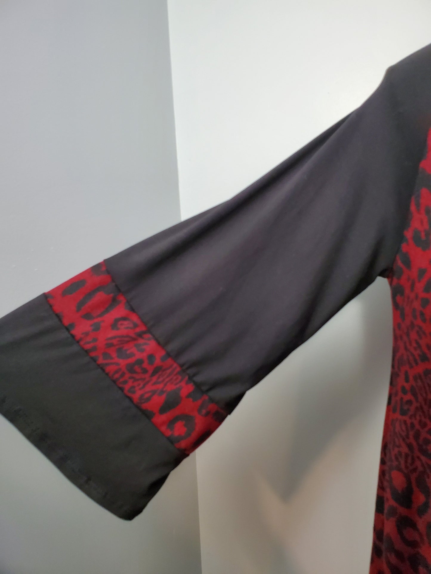 Burgundy & Black Leopard Print with Flare/Ruffle Sleeves. Key Hole Neckline Runs Big, Size Down.