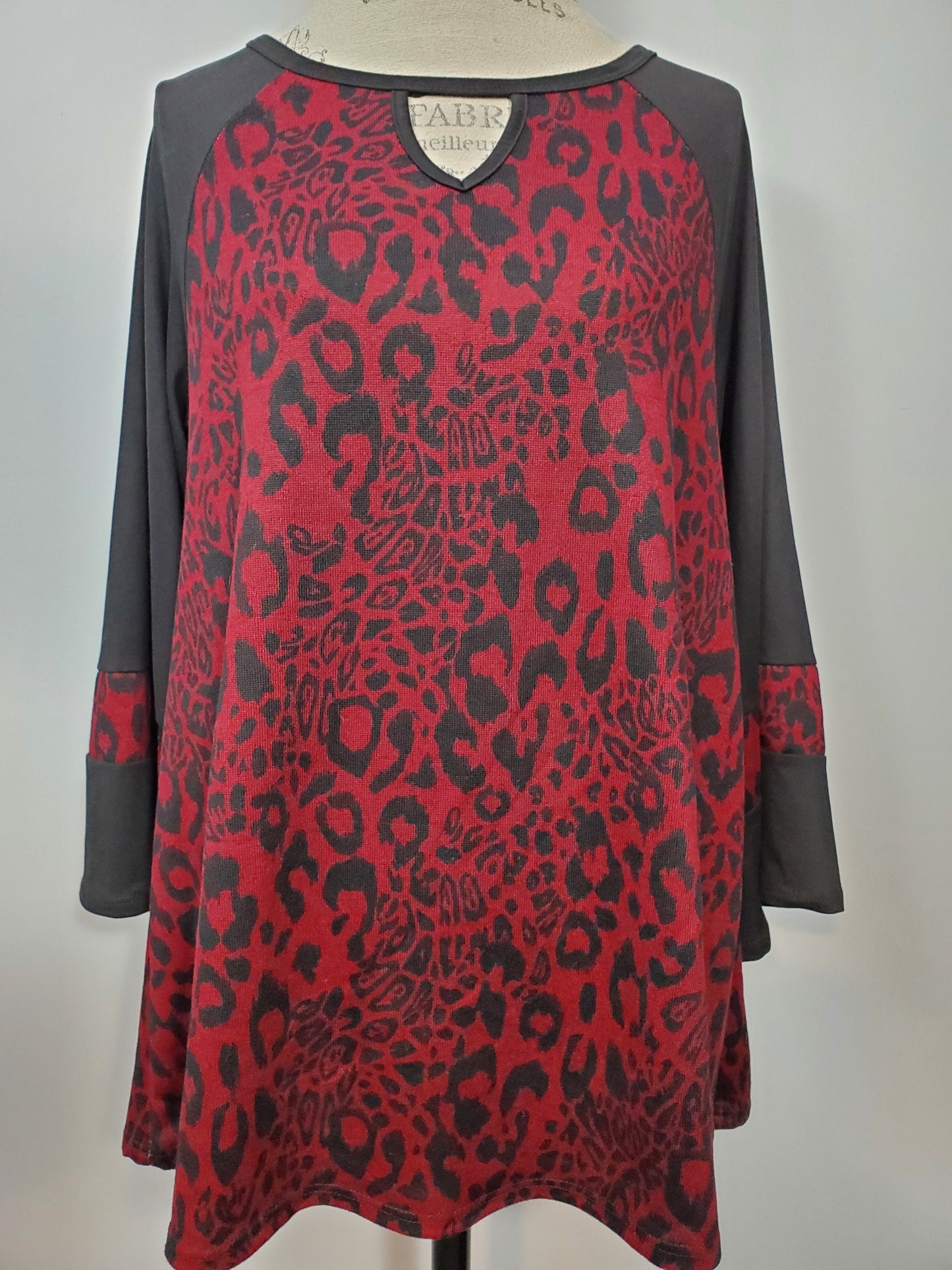 Burgundy & Black Leopard Print with Flare/Ruffle Sleeves. Key Hole Neckline Runs Big, Size Down.